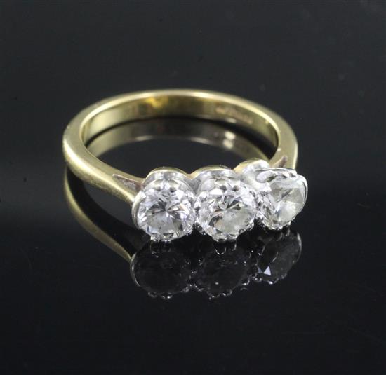 A modern 18ct gold and three stone diamond ring, size O.